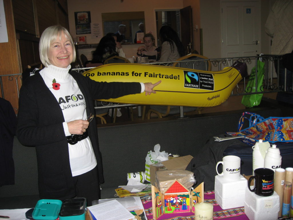 A parishoner stands with an inflatable banana to promote Fairtrade.