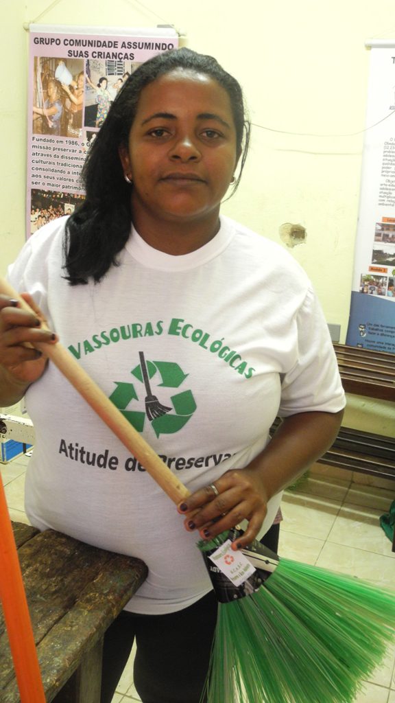 An educator who works for GSASC in Olinda, making recycled brooms for young people to sell