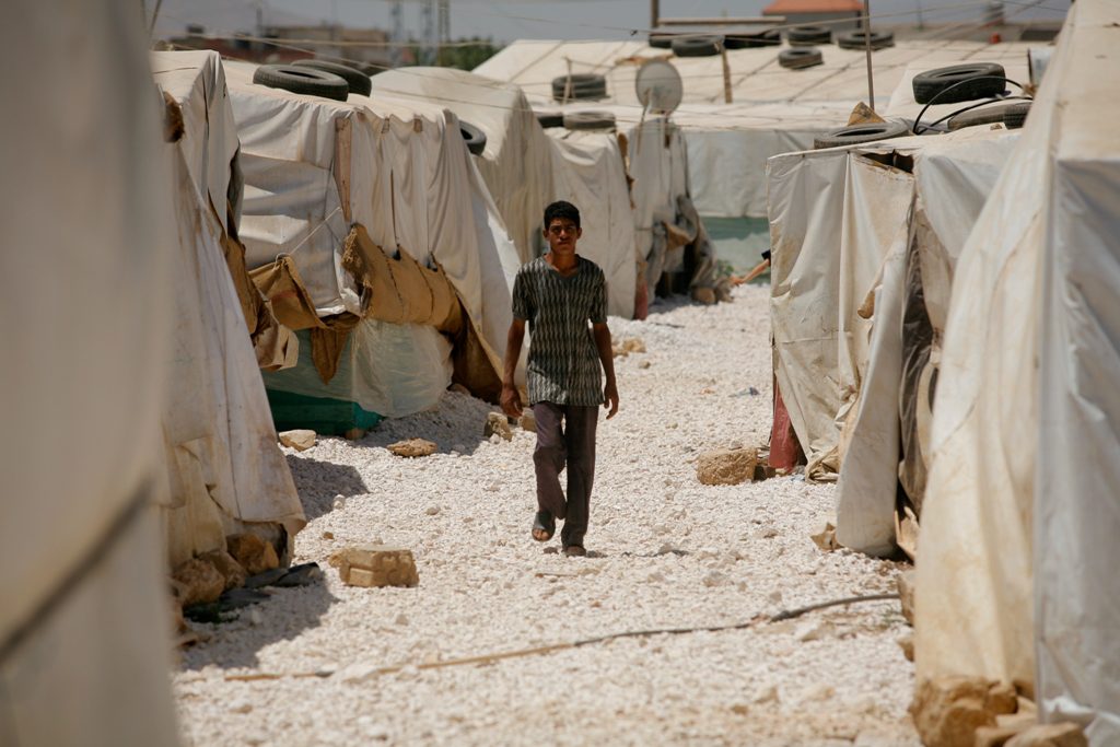 A boy walks at Dalhmieh Syrian refugee camp near Zahle, Bekaa valley, Lebanon - CAFOD.