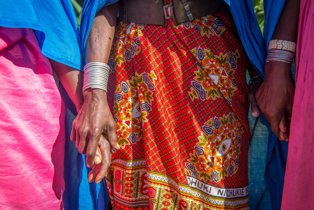 Kenyan women holding hands