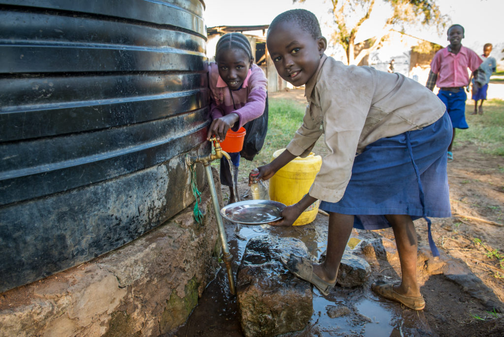 Girls collecting water at a school in Kenya