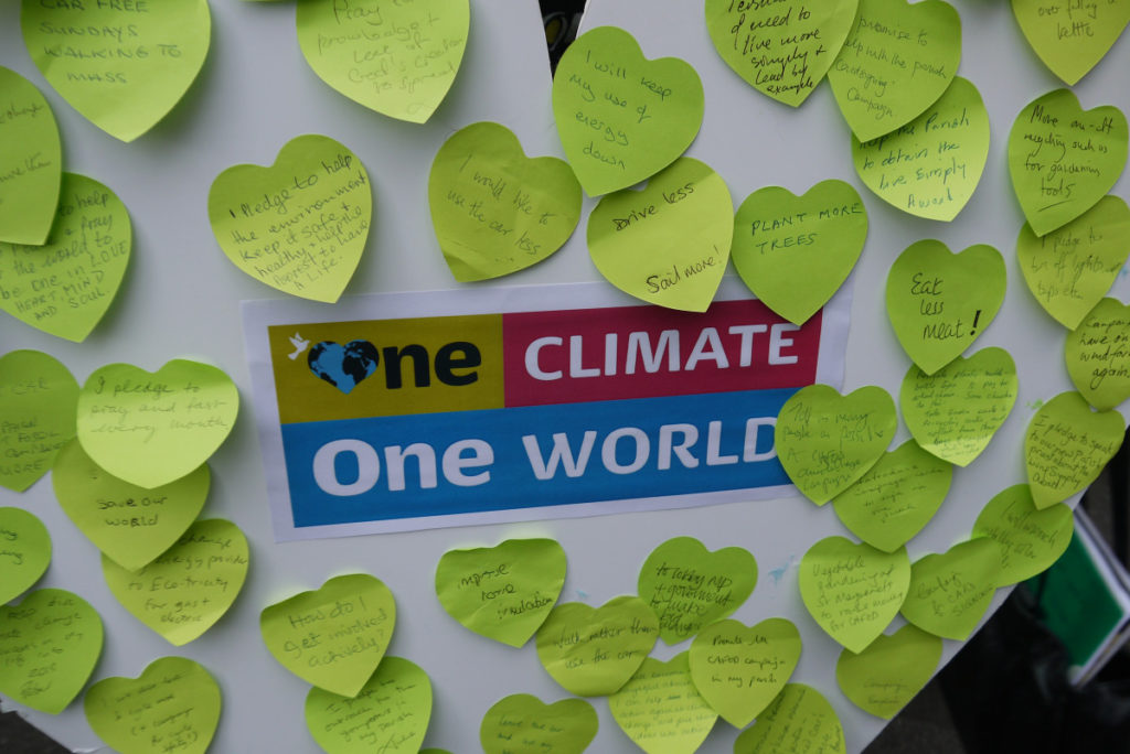 One Climate, One World heart containing lifestyle pledges