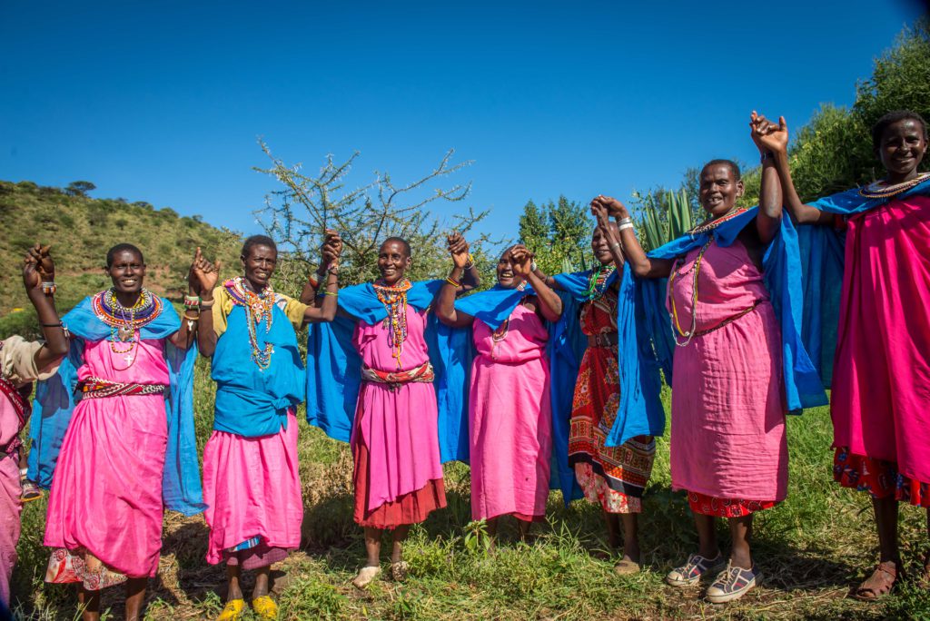 Sinteyo and women from her community outside the solar-powered greenhouse project in Kenya with CAFOD