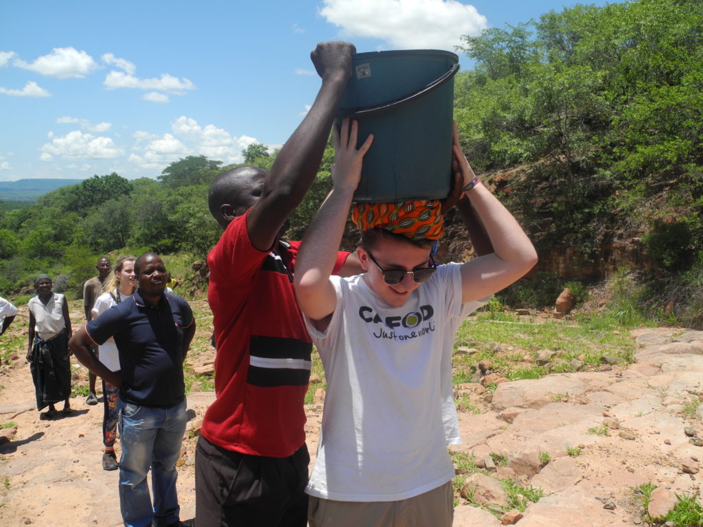 Kieron carrying water