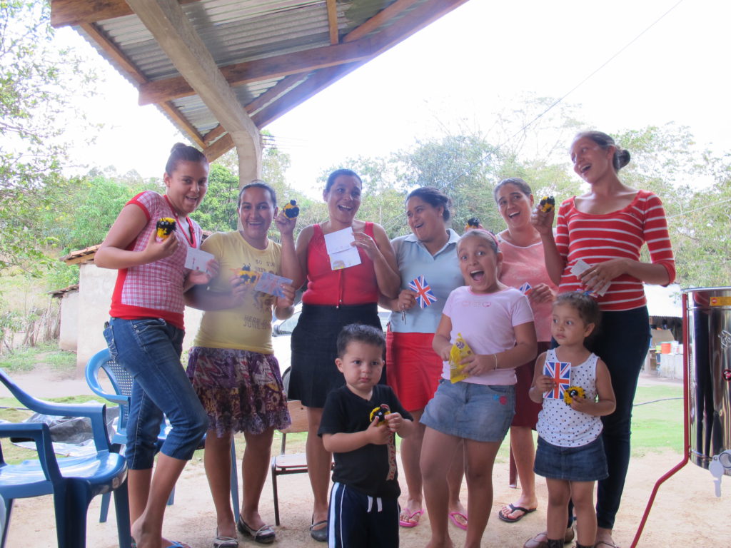 Women and children from the bee keeping cooperative supported by ASAMUPRO