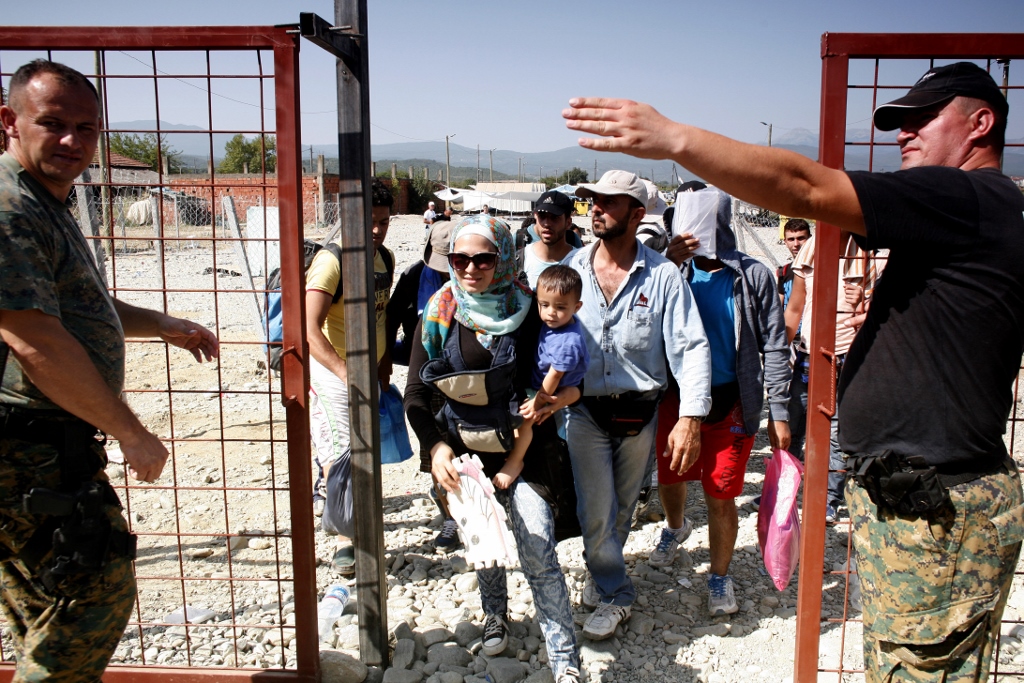 Refugees being directed at a barrier checkpoint, on their way to cross the Greek-Macedonian border.