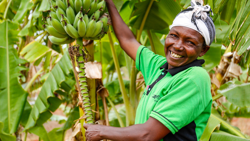 Tabitha with bananas she has grown as part of CAFOD's Hands On project