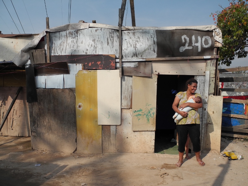 Anna Paula and her 3 month old daughter Alexandra Victoria in front of their home in Electropaulo Favela