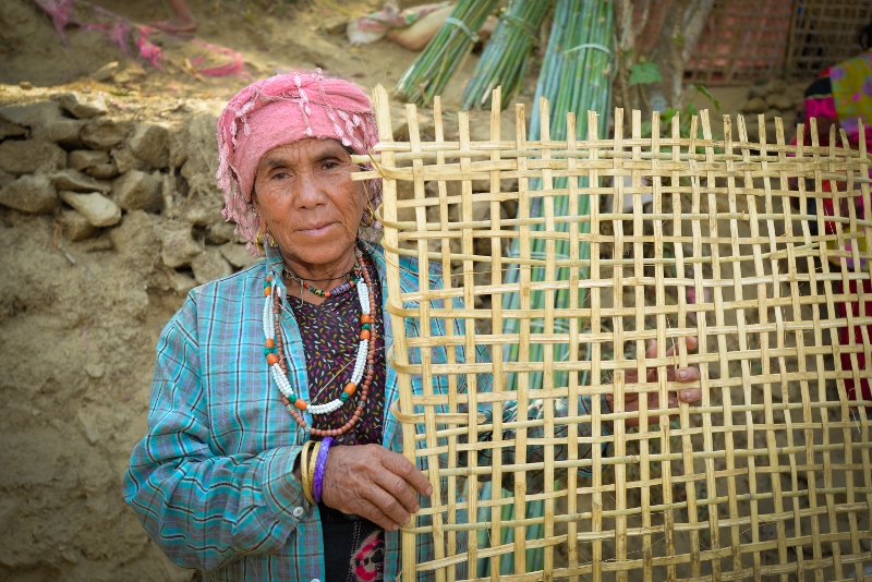 Jyotimaya, 60, uses bamboo she received from CAFOD’s partners to earn a living by making and selling baskets and fencing