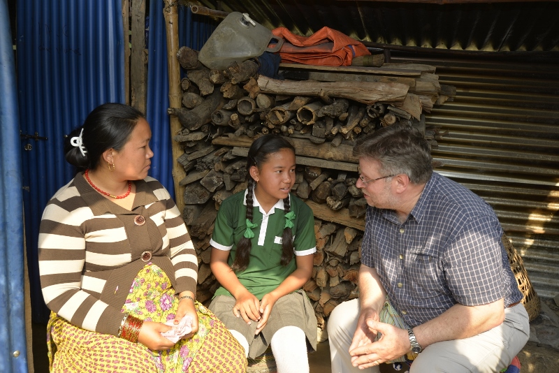 CAFOD Director Chris Bain listens as Kamala and Asmita share their story