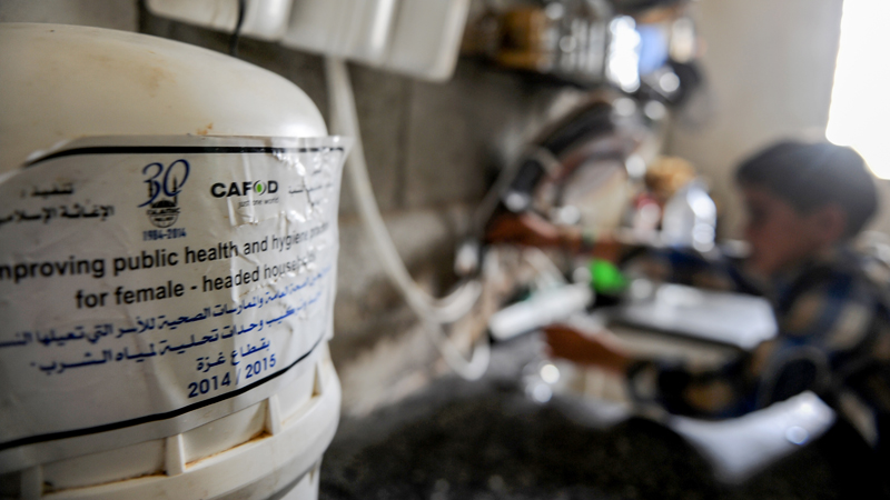 mohammed-using-a-water-filter-provided-by-cafod-in-gaza