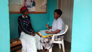 Nalwadda Nuluyati at a consultation with staff at CAFOD partner Kitovu Mobile in Uganda