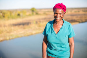 Florence near her fish pond CAFOD Lent