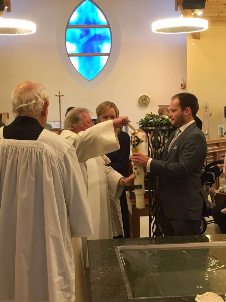 Julia and her husband in church during their son's Baptism