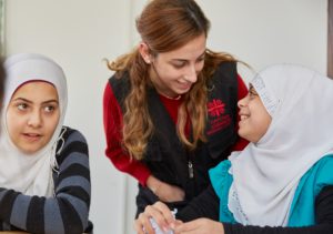 Maya, far right, with Caritas Lebanon volunteer in lessons at the migrant centre