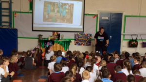 Education volunteer Margaret sharnig stories from El Salvador for Harvest Fast Day with children at St Bede's school