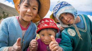 Rosa and Bernardo's children - thumbs up for their vegetable harvest in Bolivia