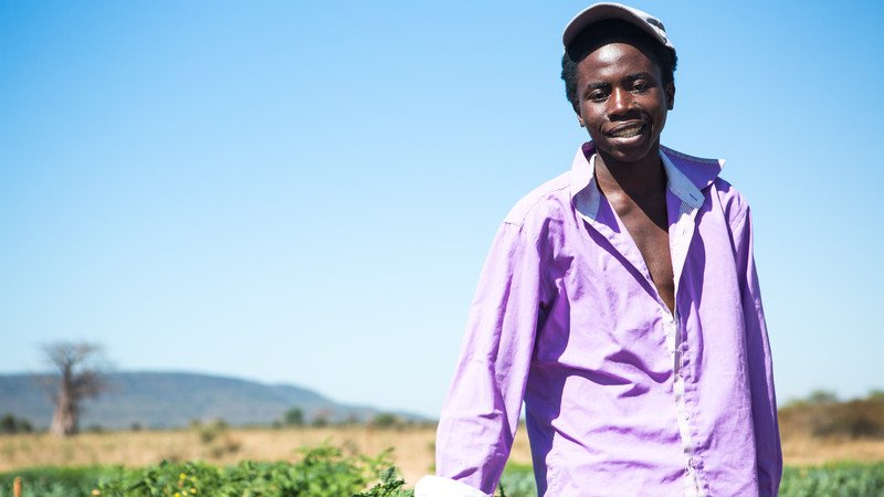 Tawanda by his vegetable garden in Zimbabwe