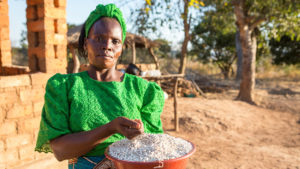 Beauty received a training on sustainable farming. Here, she holds some of the produce she has grown thanks to the Households in Distress programme in Mbala.