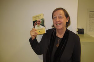 Susy Brouard holding a copy of the Laudato Si