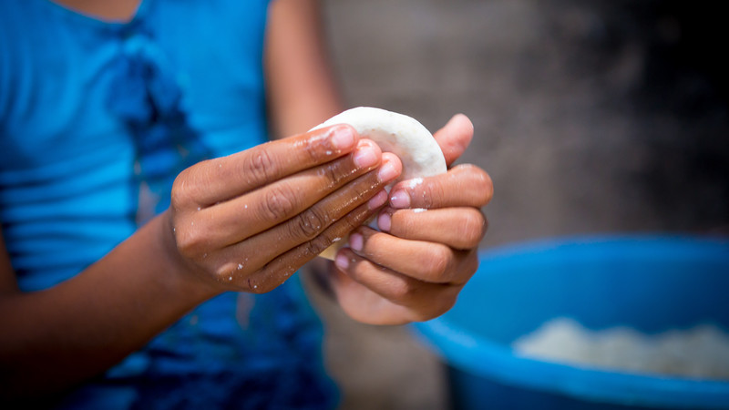 Ten-year-old Sophie from El Salvador makes tortillas with flour from home-grown maize