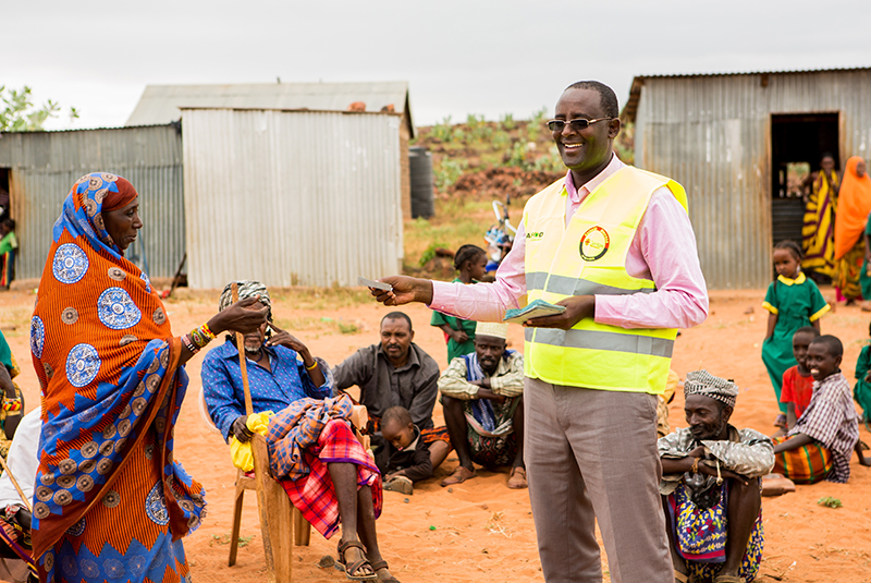 Isacko handing out food vouchers in Kenya.