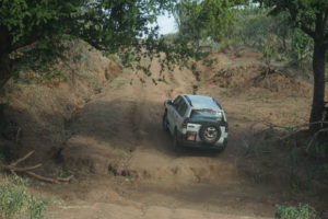 Car on dirt track in Uganda.