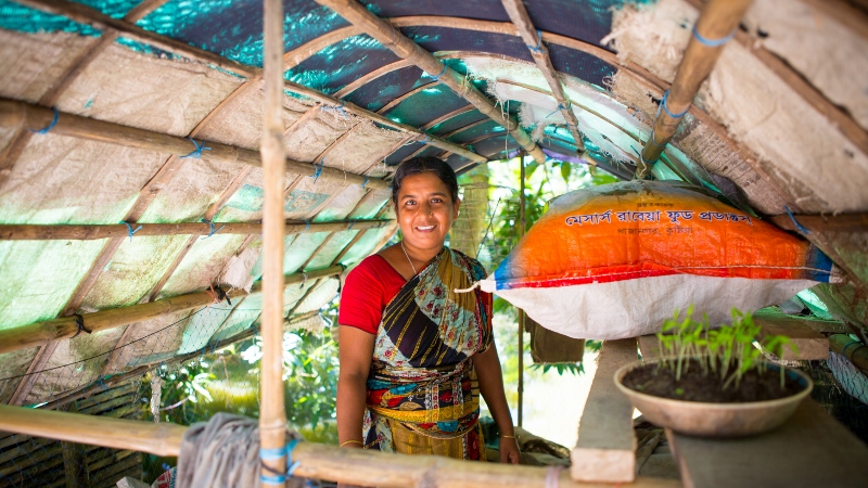 Eshita stands proudly in her greenhouse where she stores her compost