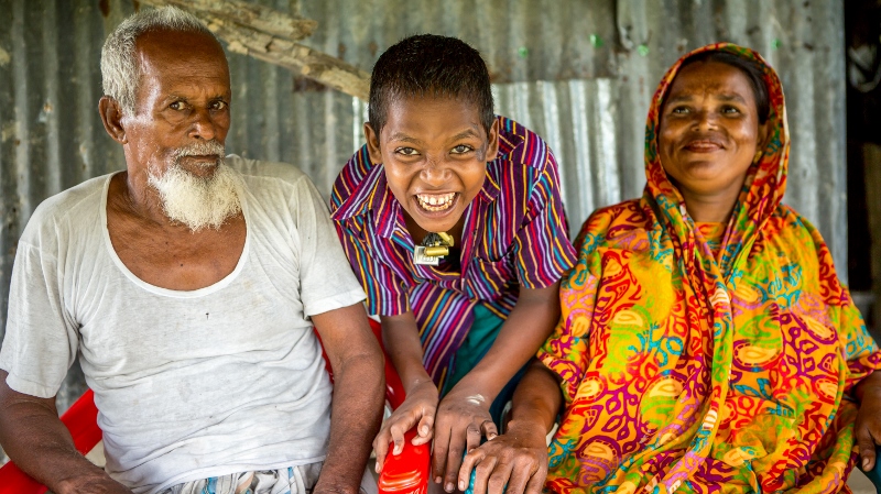 Mahinur laughing with her son Rabiul and her husband Khalek