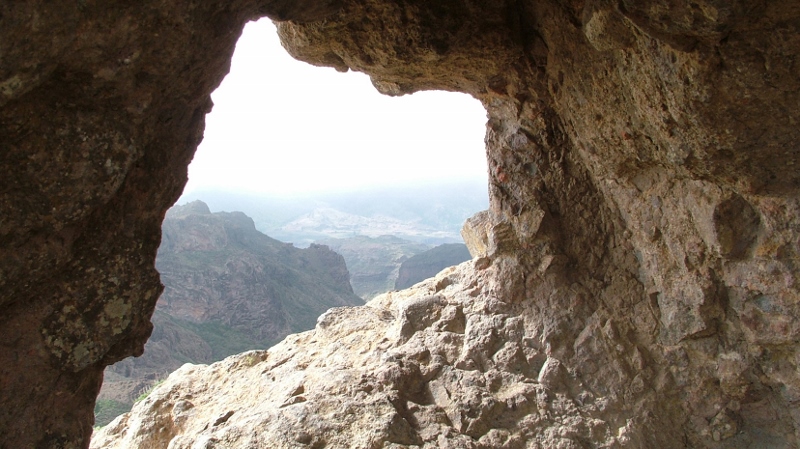 Looking out from the mouth of a cave at the mountains., giving the impression of the empty tomb.