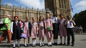 Children standing outside Parliament during the Time is Now mass lobby