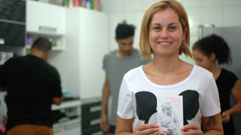 Ana Paula in Brazil holds a CAFOD postcard with a picture of Dom Helder Camara on it.