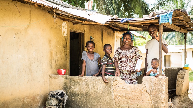 Home for life: Garmah and her family outside their home having fought for their legal rights to stay.