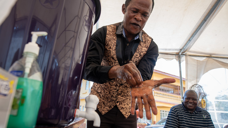 Reverend Augustine Samura-Banks washes his hands during a COVID-19 awareness training for religious leaders at CAFOD's office in Freetown