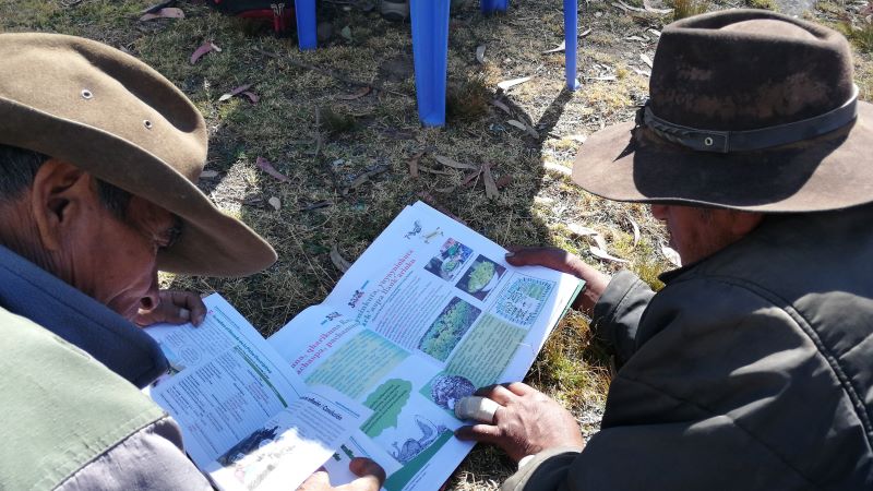 Two men reading a magazine