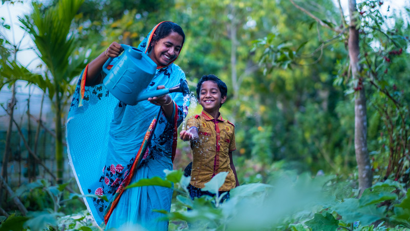 Mother and son in their garden in Bangladesh