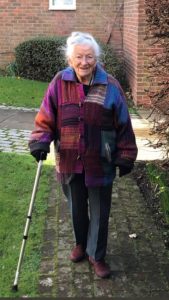 Nanny Pat walking along a path with her walking stick