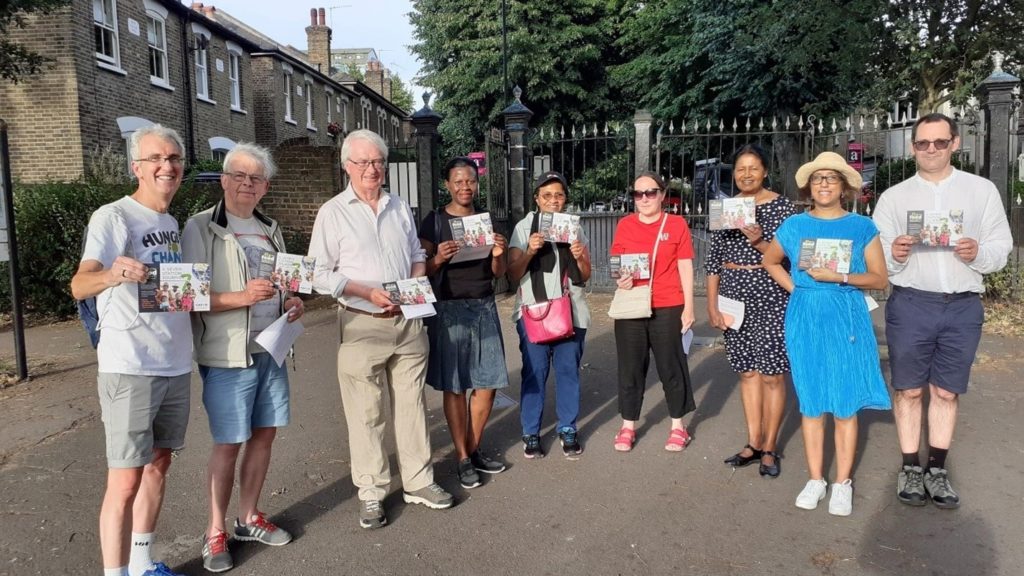 A group posing with the 7 stations literature