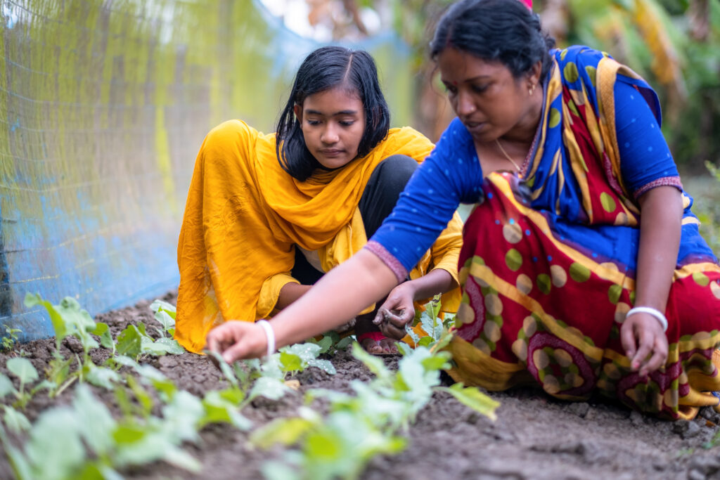 Dristi with her mother working in the vegetable garden.