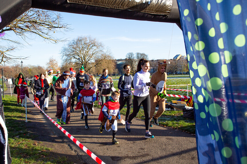 Runners cross the start line