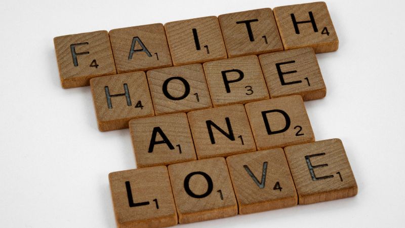 the words faith, hope and love spelt out in scrabble letters